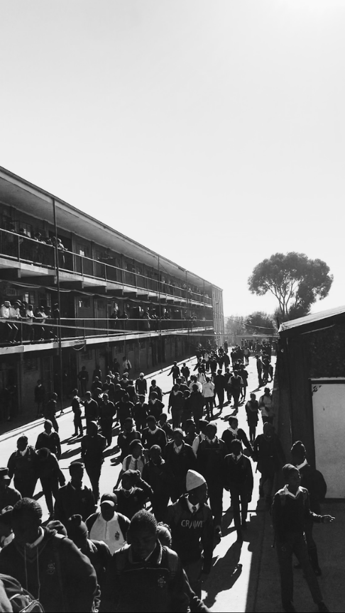 Learners walking between classroom blocks at a South African school